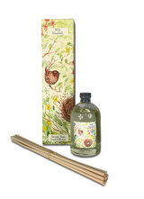 A Heaven Scent 100ml reed diffuser kit featuring a clear apothecary-style glass bottle, a bundle of 10 natural rattan reed sticks and an elegantly illustrated gift box. Aroma: Bluebell; Illustration: Wren on Nest surrounded by Spring Wild Flowers