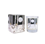 A Heaven Scent Autumn/Winter 9cl scented votive candle in a clear glass jar alongside its matching illustrated gift box. Both the candle label and the box feature. Aroma: Shiso, Frankincense & Vetiver; Illustration: Winter Moon, Moth & Moon