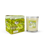 A Heaven Scent 20cl scented votive candle in a clear glass jar alongside its matching illustrated gift box. Both the candle label and the box feature. Aroma: Lavender & Geranium; Illustration: Girl & Dog.