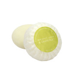 A round bar of Heaven Scent Heritage natural origin shaving soap, pleat wrapped in white paper. The top features a green circular label for the Bergamot, Lemon & Grapefruit scent.  Made in the UK using sustainable plant-based ingredients.