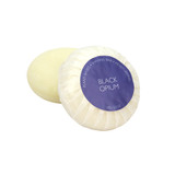 A round bar of Heaven Scent Heritage natural origin shaving soap, pleat wrapped in white paper. The top features a purple circular label for the Black Opium scent.  Made in the UK using sustainable plant-based ingredients.