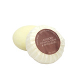 A round bar of Heaven Scent Heritage natural origin shaving soap, pleat wrapped in white paper. The top features a dark rose red circular label for the lavender, cananga cedar & patchouli scent.  Made in the UK using sustainable plant-based ingredients.