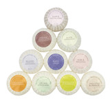 A set of 10 Heritage natural origin shaving soaps, pleat wrapped in white paper. The box features a pale pink rectangle label . Made in the UK using sustainable plant-based ingredients.