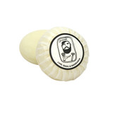 Heaven Scent Lime, Basil & Mandarin natural origin shaving soap. The round, plant-based soap is shown wrapped in traditional pleat paper, sealed with a circular label featuring a black and white Sarah Pettitt illustration of a man.