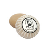 Heaven Scent Elemi & Essential Amber natural origin shaving soap. The round, plant-based soap is shown wrapped in traditional pleat paper, sealed with a circular label featuring a black and white Sarah Pettitt illustration of a man.