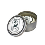 Heaven Scent Lime, Basil & Mandarin natural shaving soap for men. A rustic metal tin with an illustration of a bearded man by Sarah Pettitt on the lid. The plant-based, UK-made soap is shown pleat wrapped inside the open tin with a matching hand-drawn label.