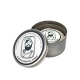 Heaven Scent Elemi & Essential Amber natural shaving soap for men. A rustic metal tin with an illustration of a bearded man by Sarah Pettitt on the lid. The plant-based, UK-made soap is shown pleat wrapped inside the open tin with a matching hand-drawn label.