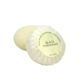 A round bar of Heaven Scent Heritage natural origin shaving soap, pleat wrapped in white paper. The top features a cream circular label for the Black Pomegranate scent.  Made in the UK using sustainable plant-based ingredients.