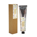 A 60ml tube of Inspiration hand cream with a Sarah Pettitt botanical illustration label, standing next to its eco-friendly brown card packaging.