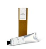 A 60ml tube of Rose Geranium cocoa & shea butter hand cream with a Heaven Scent Classic Brading label, standing next to its eco-friendly brown card packaging.