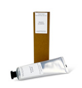 A 60ml tube of  White Jasmine cocoa & shea butter hand cream with a Heaven Scent Classic Brading label, standing next to its eco-friendly brown card packaging.