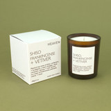 Heaven Scent Shiso, Frankincense & Vetiver natural soy and plant wax scented candle in a brown glass jar displayed beside its matching white presentation box against a green botanical background