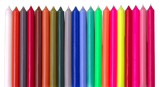 A vibrant row of 10-inch UK-made straight dinner candles showcasing a wide variety of bright colours, isolated against a clean white background.