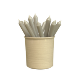 A pack of 16 bulk 10-inch UK-made straight dinner candles in elephant grey, arranged in a neutral cream stoneware pot isolated against a clean white background.