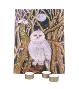 Wholesale 12-day Christmas advent calendar with a snowy owl illustration by Sarah Pettitt, displayed alongside three scented soy tealights.