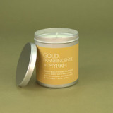 Heaven Scent Gold, Frankincense & Myrrh festive vegan natural soy and plant wax scented candle in a travel tin displayed beside its lid against a green botanical background