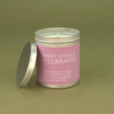 Heaven Scent Sweet Vanilla & Currants vegan natural soy and plant wax scented candle in a travel tin displayed beside its lid against a green botanical background