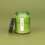 Green Botanical 150ml pharmacy jar Celandine scented candle by Heaven Scent in a glass jar with a black lid.