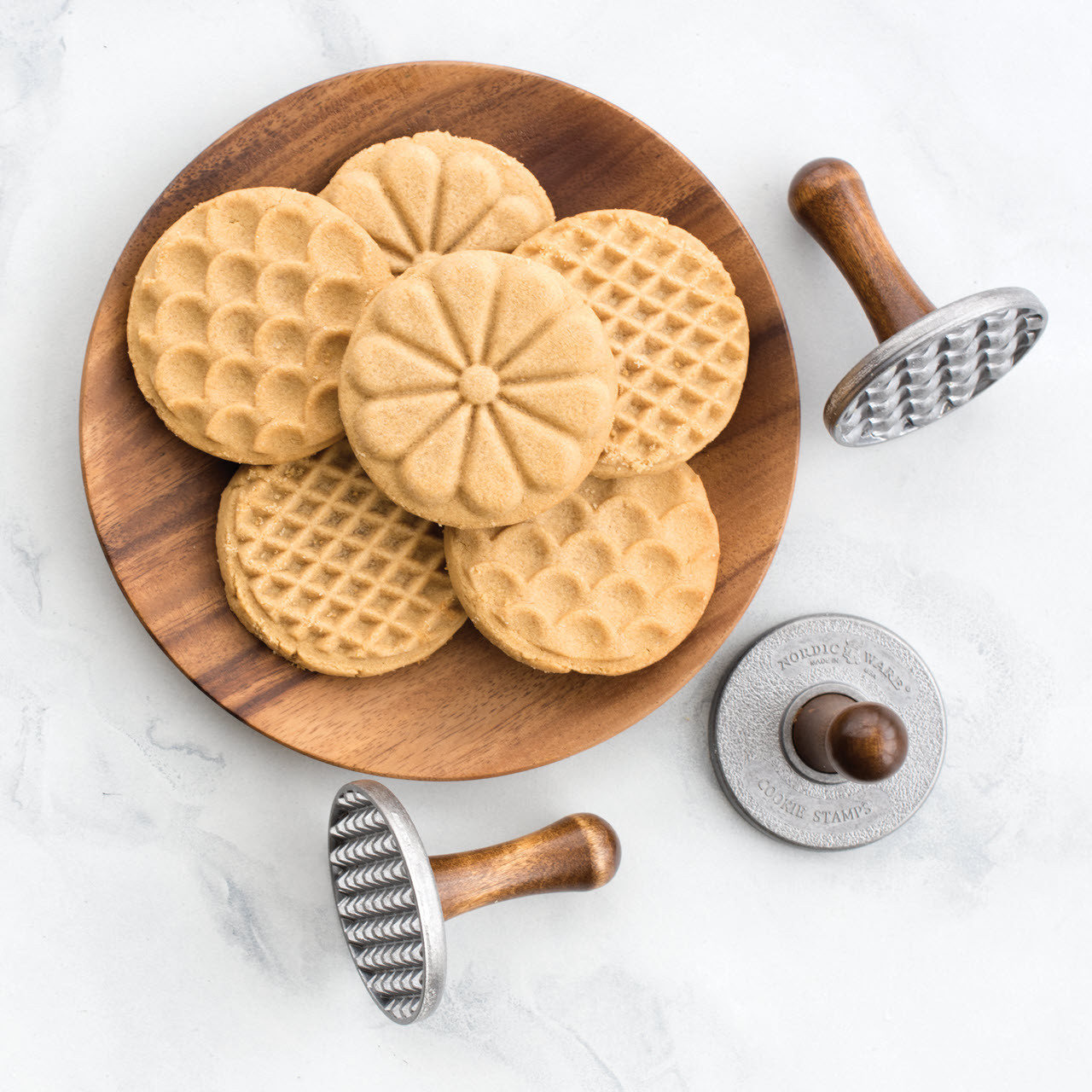 https://cdn11.bigcommerce.com/s-21kj3ntgv1/images/stencil/1280x1280/products/466/1608/Nordic-Ware-Heirloom-Cookie-Stamps-with-cookies-__39771.1658092641.jpg?c=2