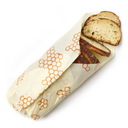 A Bee's Wrap bread wrap in Honeycomb Print wrapping bread.