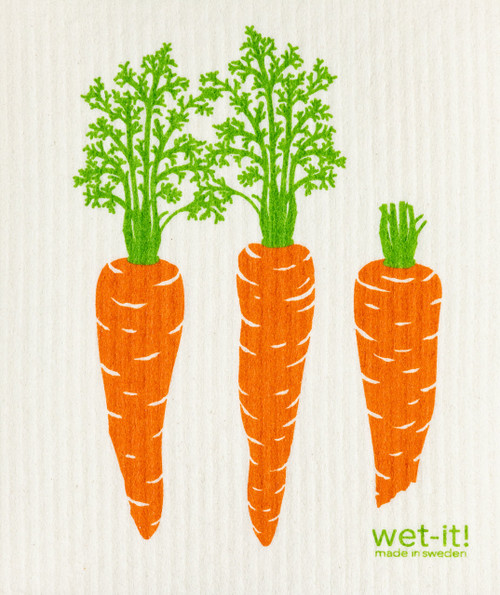 Three carrots on an off white Swedish cloth