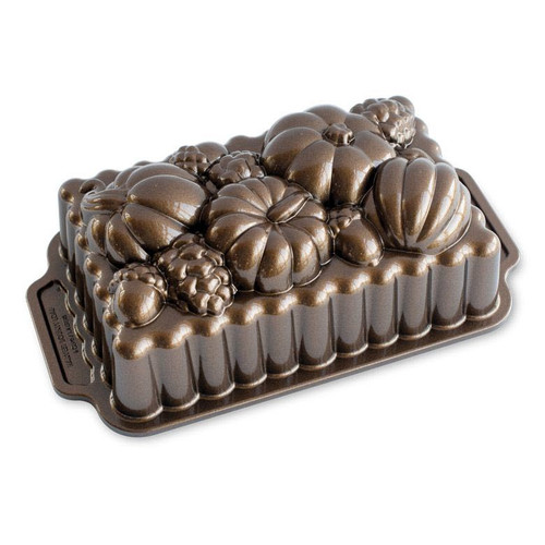 Nordic Ware Harvest Bounty Loaf Pan Bronze on a white background with the design up