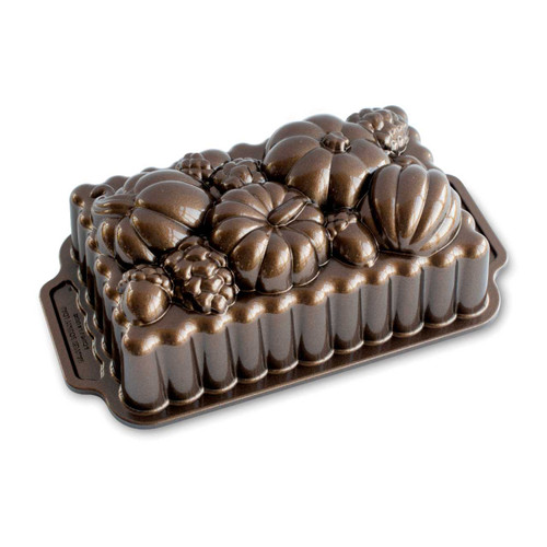 Nordic Ware Harvest Bounty Loaf Pan Bronze on a white background with the design up.