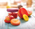 Food Huggers filled with fruit and covering a jar on a table