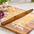 An Ironwood French rolling pin on a kitchen counter with fresh pasta dough.
