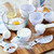 The Fox Run 7 Piece Measuring Cup Set is on a cutting board with other baking items.