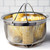 The RSVP Endurance Stainless Steel Mesh Basket filled with Corn
