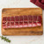 A perfectly tied beef tenderloin on a cutting board.