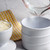 A RSVP International butter pot open with the pot being filled with water