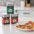 The 3 tins of the Spicewalla Mediterranean Collection stacked on a kitchen counter next to a slice of pepperoni pizza on a plate