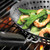 An alternate view of the Outset Nonstick BBQ Skillet cooking shrimp and snow peas