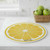 The Wet-It! Lemon Round Swedish Cloth on a kitchen counter with a basket of green apples