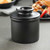 A classic black matte Butter Bell Crock with the lid on