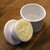 Petite Butter Bell Crock in white open on a wood cutting board