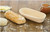 11-Inch Oval Banneton Basket with dough and a loaf of baked bread