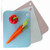 Three of the Kitchen Basics kitchen cutting mats fanned out with a bell pepper and carrots