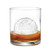 An golf ball ice in a glass with whiskey