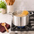 The Heritage Steel Titanium Series 5 Quart Sauce pot is boiling spaghetti