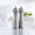 A close view of the Trudeau 8 Inch Professional Stainless Steel Salt Mill and Pepper Mill Set on a kitchen counter.