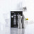 The Trudeau 8 Inch Professional Stainless Steel Salt Mill and Pepper Mill Set on a kitchen counter next to the packaging.