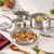 The GreenPan Venice Pro 7 Piece Cookware Set sits on a kitchen counter, with components for making a chicken dinner with a creamy sauce, green beans, and pasta.