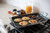 Nordic Ware Two Burner High-Sided Griddle with pancakes and sausage on a stove