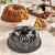 The Nordic Ware Bavaria Bundt Pan on a kitchen island with a baked Bavaria Bundt and a coffee tray.