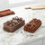 A cake baked in the Nordic Ware Harvest Bounty Loaf Pan alongside the pan on a kitchen island.
