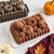 A cake baked in the Nordic Ware Harvest Bounty Loaf Pan alongside the pan with minimalistic fall accents.