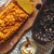 A pumpkin oaf cake made with the Nordic Ware Wheat & Pumpkin Loaf Pan on a cutting board with the pan